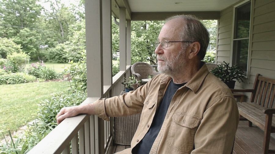 Tom Bennett looking out from a porch